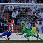Atletico Madrid's Antoine Griezmann, left, scores past Real Madrid's goalkeeper Keylor Navas, centre, the equalizing goal during the La Liga soccer match between Real Madrid and Atletico Madrid at the Santiago Bernabeu stadium in Madrid, Saturday, April 8, 2017. Griezmann scored once and the match ended in a 1-1 draw. (AP Photo/Francisco Seco)