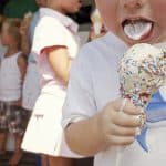 56621320
Lifestyle - childhood.
Boy (3-5) eating ice cream, close-up, other children in background