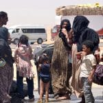 People wait to cross into Egypt through the Argeen land port with Sudan on April 27, 2023. Egypt has received more than 16,000 foreigners fleeing the deadly conflict in neighboring Sudan, including more than 14,000 Sudanese, the Egyptian Foreign Ministry said in a statement on Thursday. (Photo by Radwan Abu Elmagd/Xinhua)