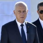 Tunisian President Kais Saied arrives with his wife to vote in a referendum on a draft constitution he put forward, at a polling station in the capital Tunis, on July 25, 2022. - The vote is seen as a referendum on Saied, whose charter would give his office nearly unchecked powers in a break with the country's post-2011 democratic trend. (Photo by WASSIM JDIDI / AFP) (Photo by WASSIM JDIDI/AFP via Getty Images)