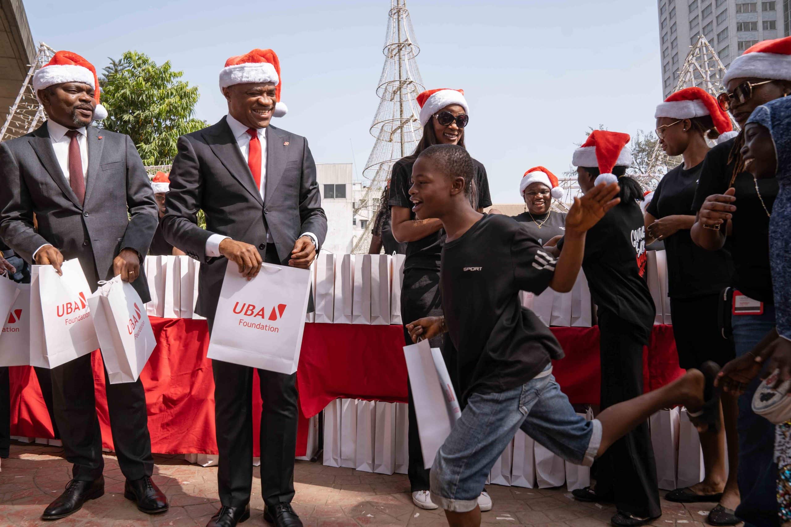 L-R: Group Deputy Managing Director, United Bank for Africa(UBA), Muyiwa Akinyemi; GMD/CEO, Oliver Alawuba; and Managing Director/CEO, UBA Foundation, Bola Atta with some beneficiaries of UBA Foundation Annual Food Bank initiative, where the Foundation served foods to the less privileged and individuals in need, around the bank’s headquarter in Marina, Lagos...on Thursday.