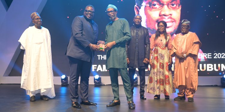 2024 Winner of The Nigeria Prize for Literature, Familoni Olubunmi (R) receives his plaque from Olakunle Osobu, Deputy MD, NLNG, at the Grand Award Night. With them are (L-R)  Prof Ahmed Yerima (Board member), Dr Philip Mshelbila, NLNG MD, Prof Akachi Adimora-Ezeigbo (Chairman) and Prof Olu Obafemi, (Board member) of the Literature Prize Advisory Board