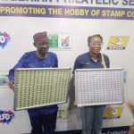 Alt="Ms Tola Odeyemi, Post Master General of the Federation with Mr Taiye Olaniyi, an ex-post master while unveiling a single postage stamp in commemoration of the Universal Postal Union’s 150th anniversary, in Lagos, on Wednesday"