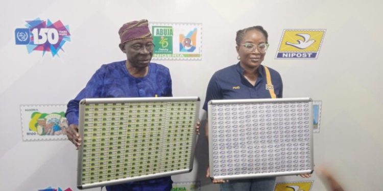 Alt="Ms Tola Odeyemi, Post Master General of the Federation with Mr Taiye Olaniyi, an ex-post master while unveiling a single postage stamp in commemoration of the Universal Postal Union’s 150th anniversary, in Lagos, on Wednesday"