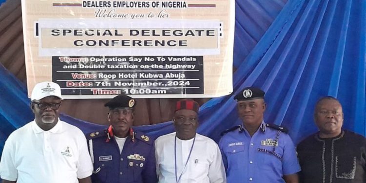 Alt="L-R: The Representative of the Ministry of Steel Development, Mr Fredrick Ewa, Deputy Commandant Adebayo Bello of NSCDC, the President of NASWDEN, Mr John Obeh and ACP Sule Abel representing the IGP at the Extraordinary Special Delegates Conference of the NASWDEN"
