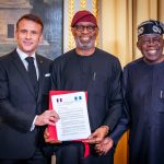 R-L: President Bola Tinubu;  Solid Minerals Development Minister, Dr. Dele Alake and President of France, Emmanuel Macron, displaying the Memorandum of Understanding (MOU) on Solid Minerals Development between both countries during Tinubu's official visit to France
