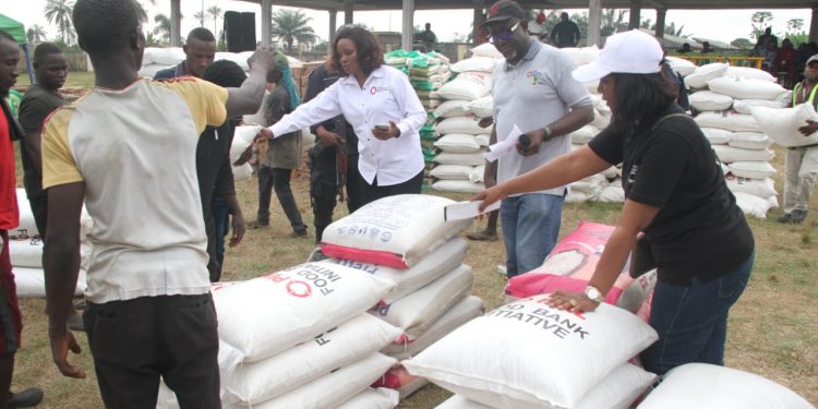 Miss Deborah Okunbo, Chief Executive Officer (CEO), Learn and Leadwise Resources Limited (in white long sleeves shirt), supervising the distribution of the palliatives.