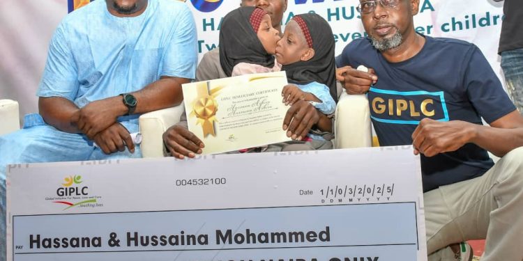 L-R: Chief Operating Officer (COO), Dickens Sanomi Foundation, Mr. Goodluck Hayi; Conjoined Twins, Hassana and Hussaina; their father, Mohammed Ashiru and National Coordinator, Global Initiative for Peace, Love and Care (GIPLC), Nuhu Fulani Kwajafa, during the presentation of N200 million in cheques to conjoined twins (Hassana & Hussaina), and 11 other children, organised by GIPLC in Abuja.